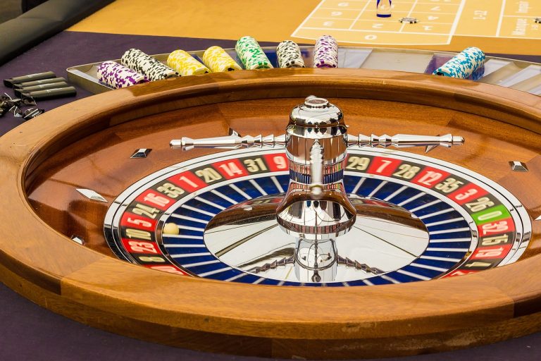 Martingale strategy concept: a casino roulette wheel with red and black pockets and stacks of chips