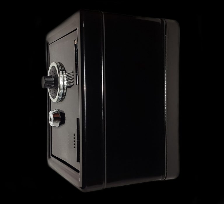 Box spread options concept: a small black steel safe with a combination dial, like a position locked to a fixed payoff