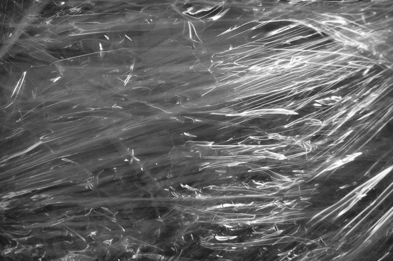 UFLEX credit rating: crumpled transparent plastic packaging film, the kind of flexible film UFLEX makes