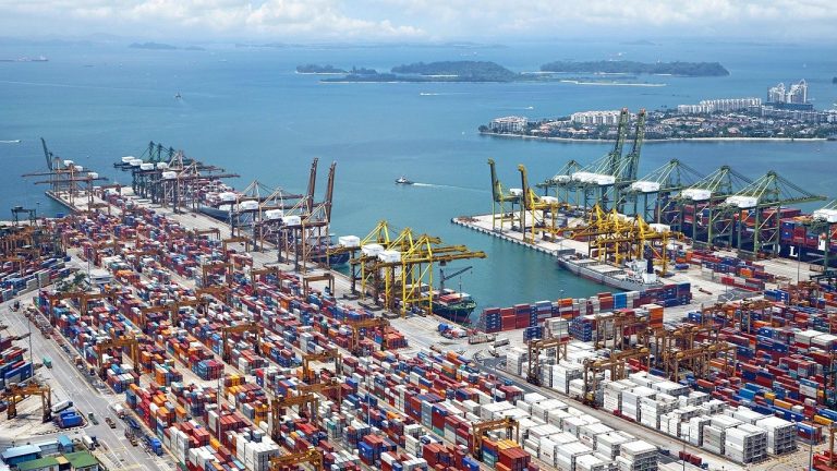 Adani Ports Q2 results: aerial view of a busy container port with cranes and stacked containers