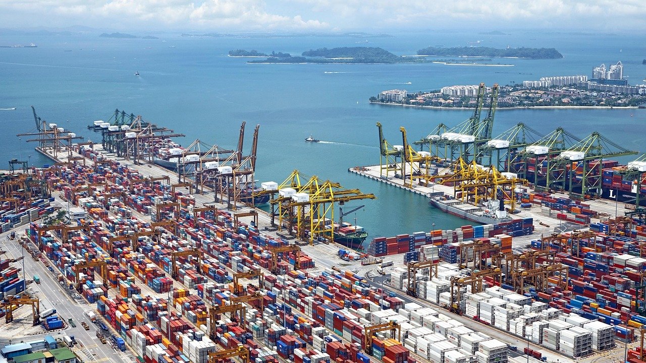 Adani Ports Q2 results: aerial view of a busy container port with cranes and stacked containers