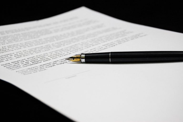 Share warrants meaning: a fountain pen resting on a printed agreement awaiting signature