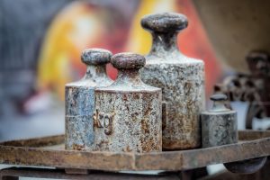 Arbitrage fund: old iron weights resting on a market scale
