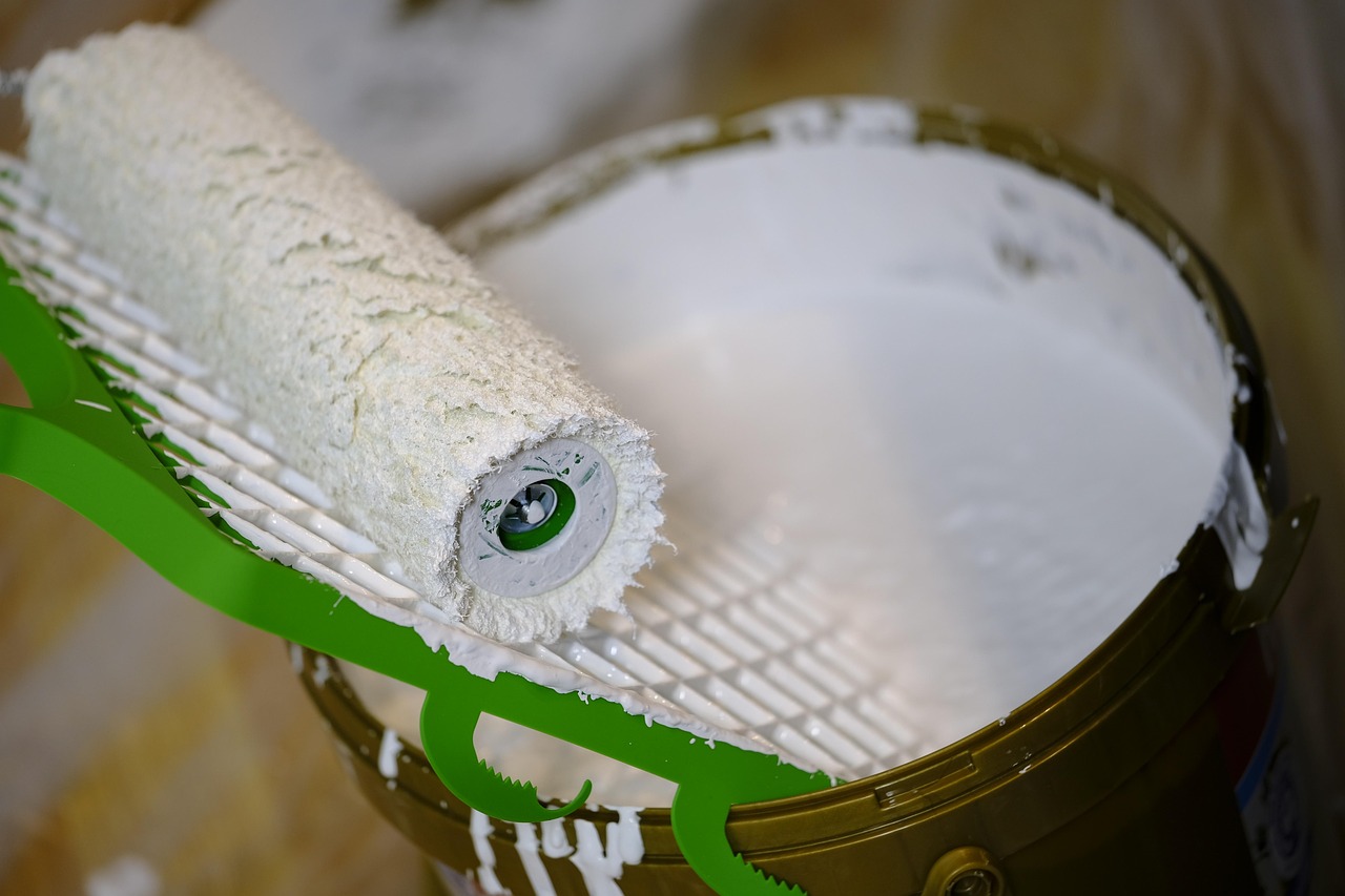 Asian Paints Q2 results: paint roller resting on an open bucket of white paint