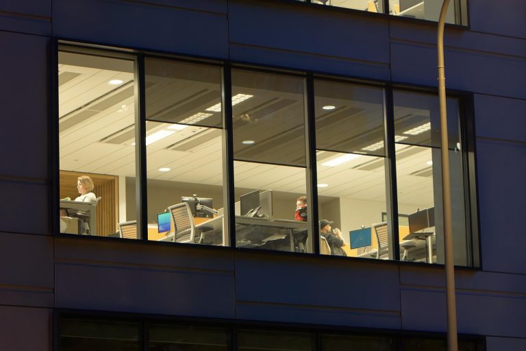 Attrition rate in IT results: half-empty IT office floor lit up at night
