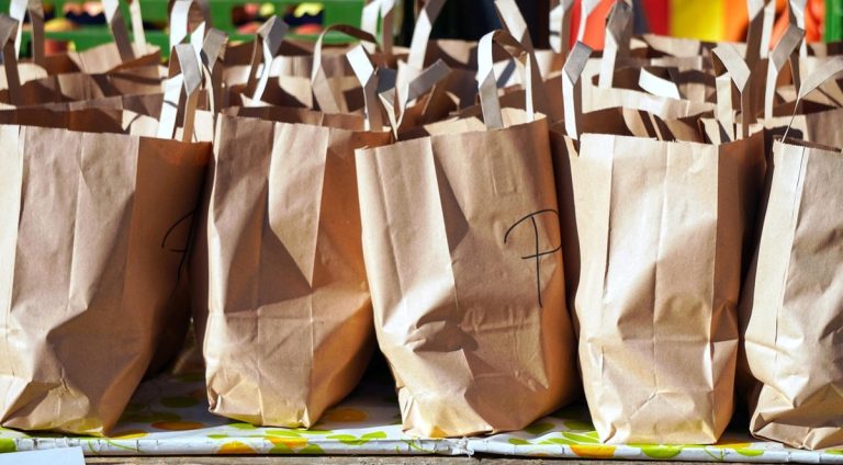 Bajaj Finance Q2 results: a row of brown paper shopping bags lined up on a table