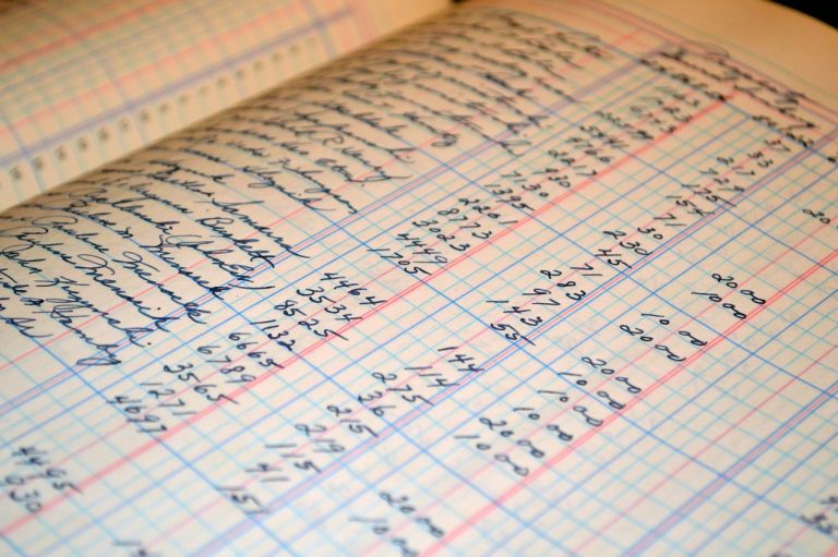 Benford's law in financial statements: handwritten figures in the columns of an old accounting ledger