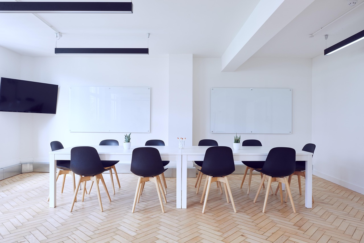 Preferential allotment of shares: an empty company boardroom with a long table and chairs
