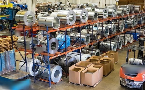 Bombay Coated and Special Steels IPO: steel coils stacked on racks in a processing warehouse