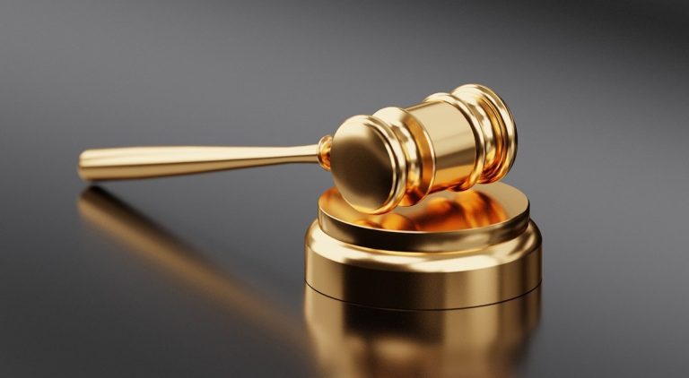 Book building process: a golden auction gavel on a dark surface, a symbol of IPO price discovery
