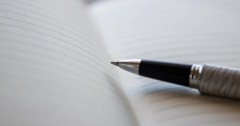 Breakeven stop loss strategy - person writing notes desk
