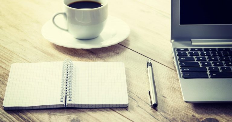Bull call spread strategy - notebook pen coffee desk