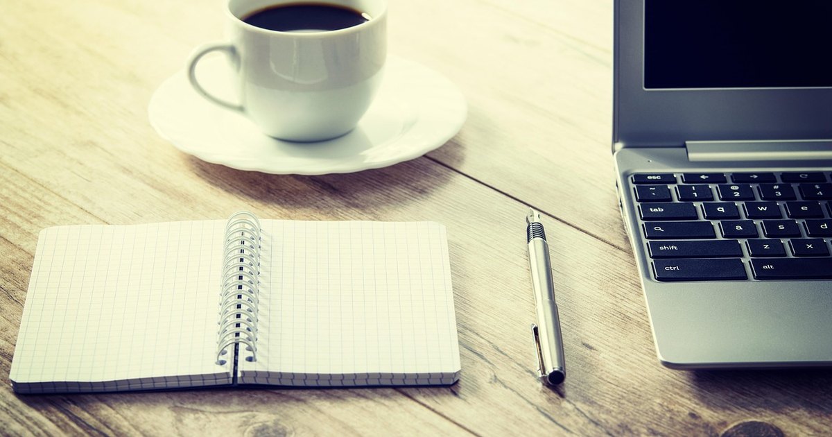Bull call spread strategy - notebook pen coffee desk