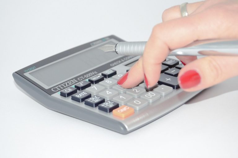 DuPont analysis: a hand working out return on equity ratios on a desk calculator
