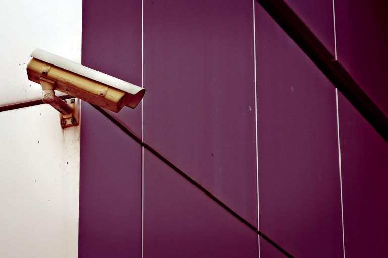 SIS buyback: a surveillance camera mounted on an office building wall