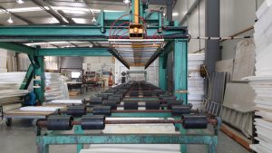 Capacity utilisation: an empty roller conveyor production line inside a factory hall