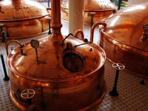 Carlsberg India IPO: copper brew kettles inside a beer brewery