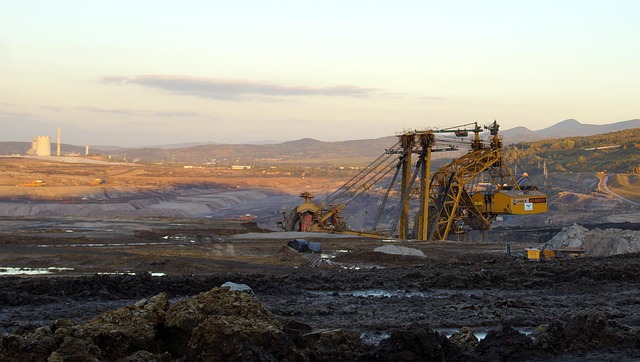 Coal India Q2 results: excavator working an open-cast coal mine at dusk