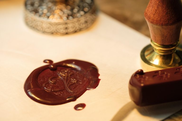 Confidential pre-filing IPO: a red wax seal pressed on paper beside a brass seal stamp