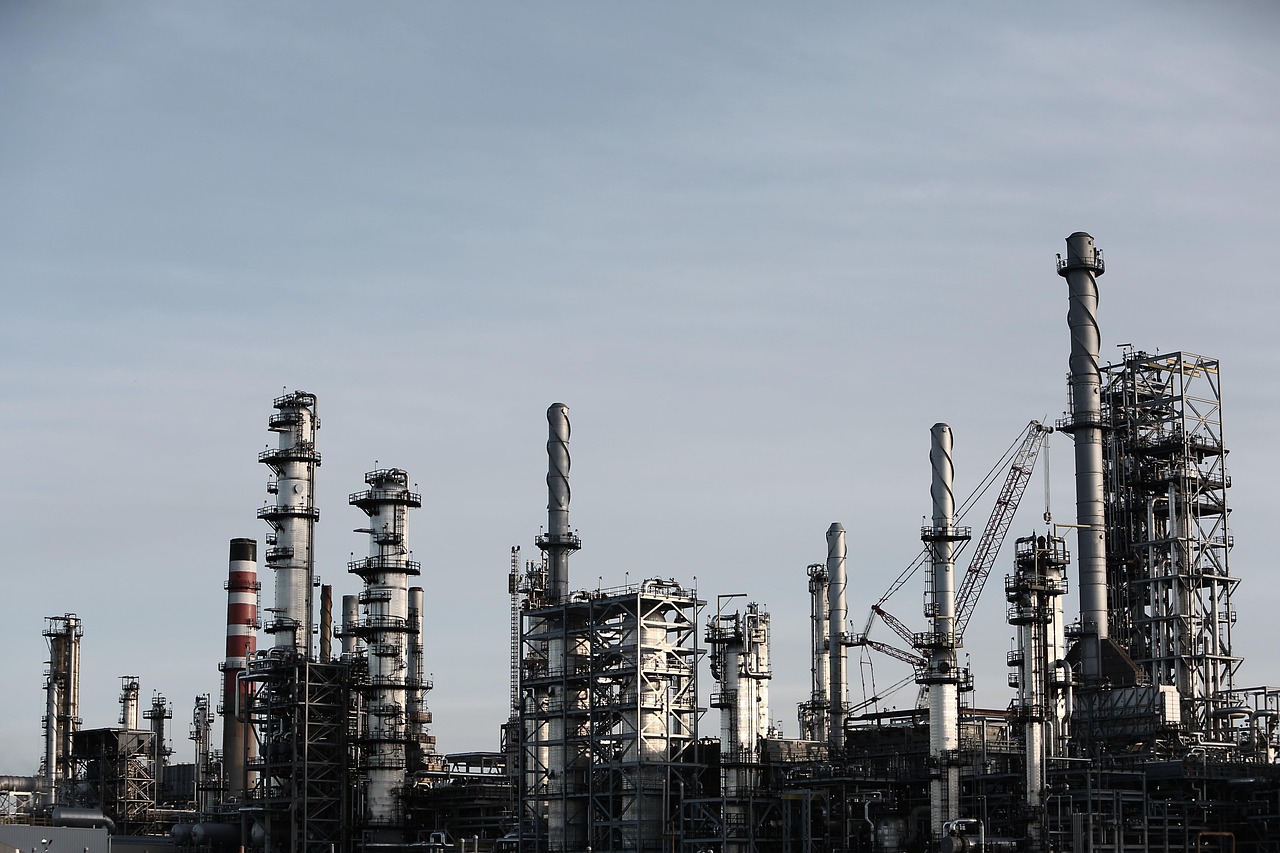 Deepak Nitrite Q2 results: towers and pipework of a large chemical manufacturing plant against a grey sky