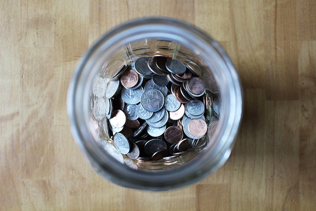 Defensive interval ratio: a glass jar of coins seen from above, a cash cushion set aside for daily expenses
