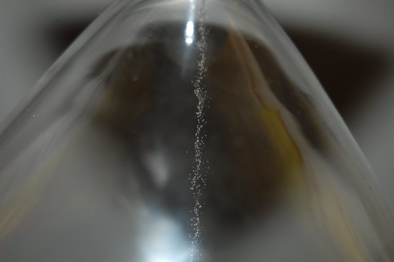 Double calendar spread: close-up of sand trickling through an hourglass, a picture of time decay