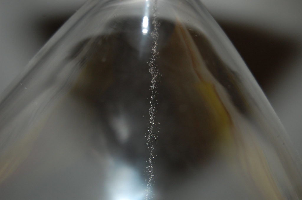 Double calendar spread: close-up of sand trickling through an hourglass, a picture of time decay