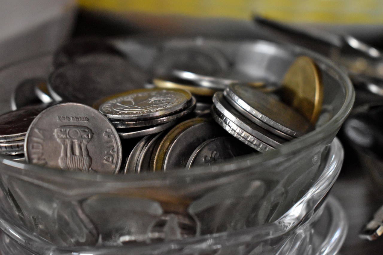 DP charges: Indian rupee coins piled up in a glass bowl