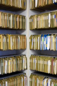 Duplicate share certificate request: rows of shareholder record files in an archive