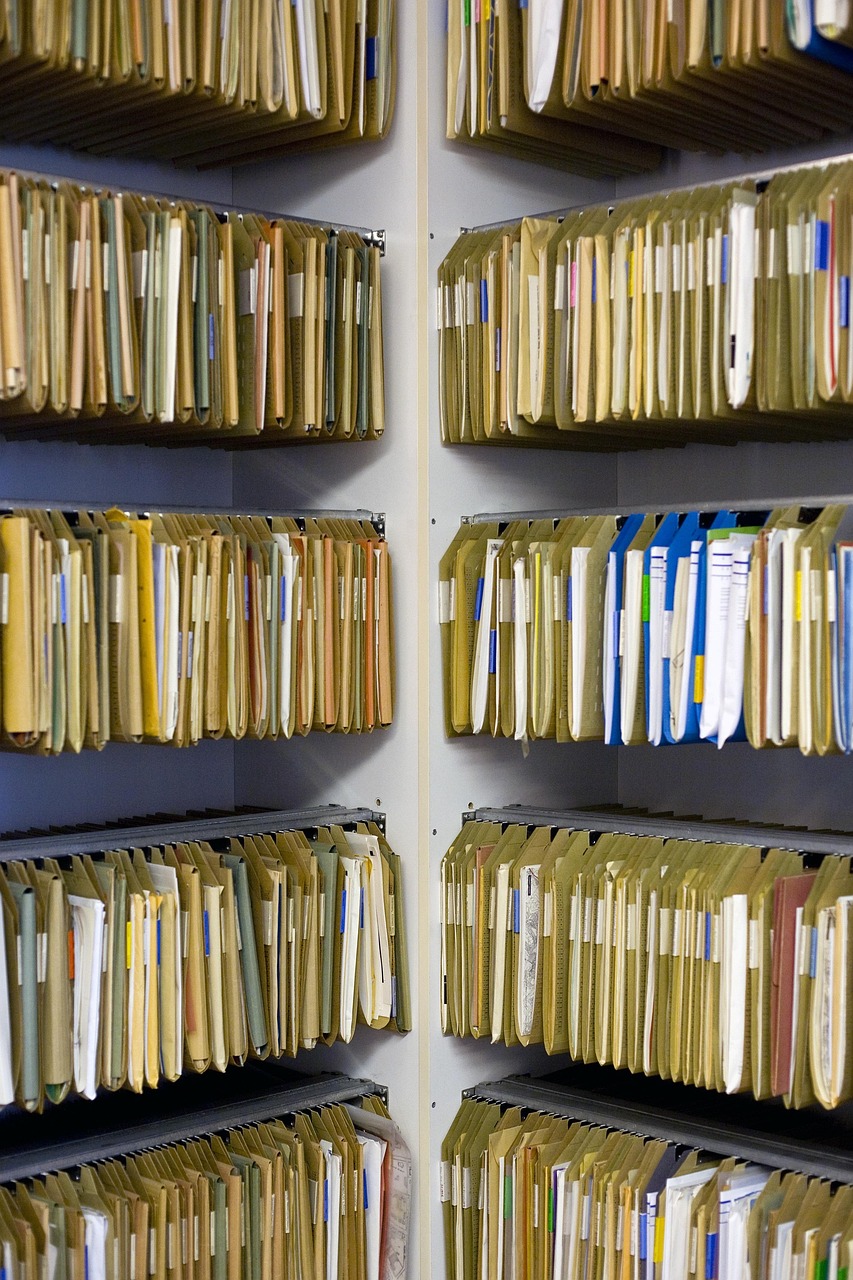 Duplicate share certificate request: rows of shareholder record files in an archive
