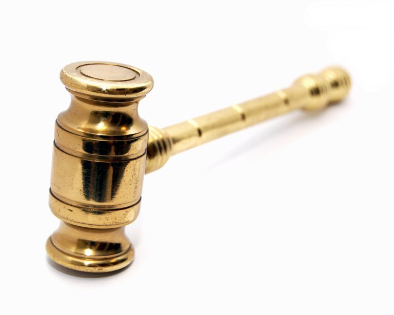 Dutch auction IPO: a polished brass auction gavel on a white background