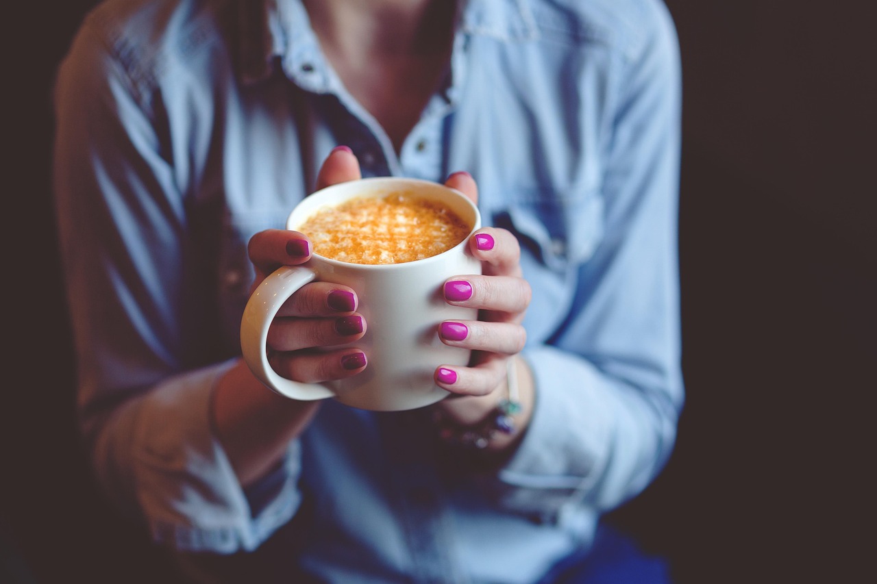 Endowment effect: hands holding a coffee mug, the classic ownership experiment