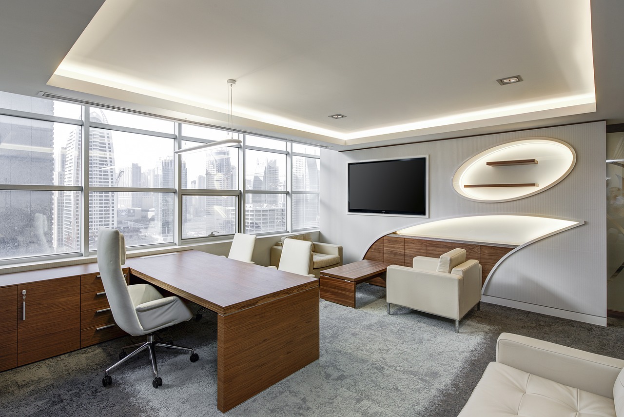 Equitas SFB CEO resigns: an empty executive office with a desk and chair overlooking city towers
