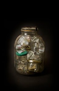 Equity savings fund: small jars of money stacked inside one large glass jar