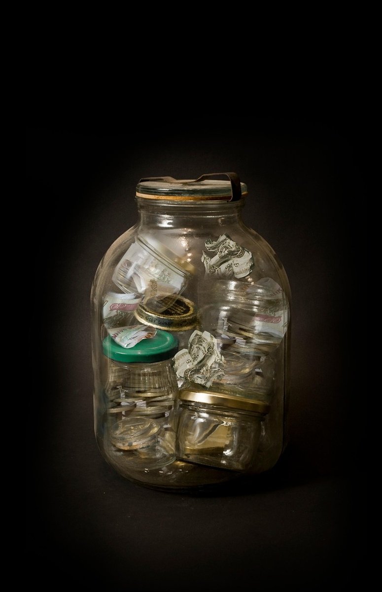 Equity savings fund: small jars of money stacked inside one large glass jar