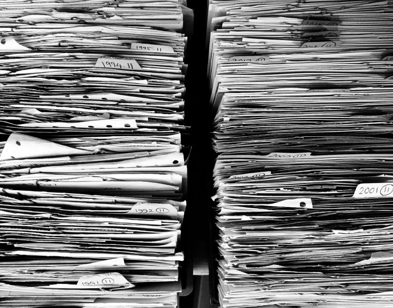 ICICI Life tax demand: stacks of old paper files from past years piled on shelves