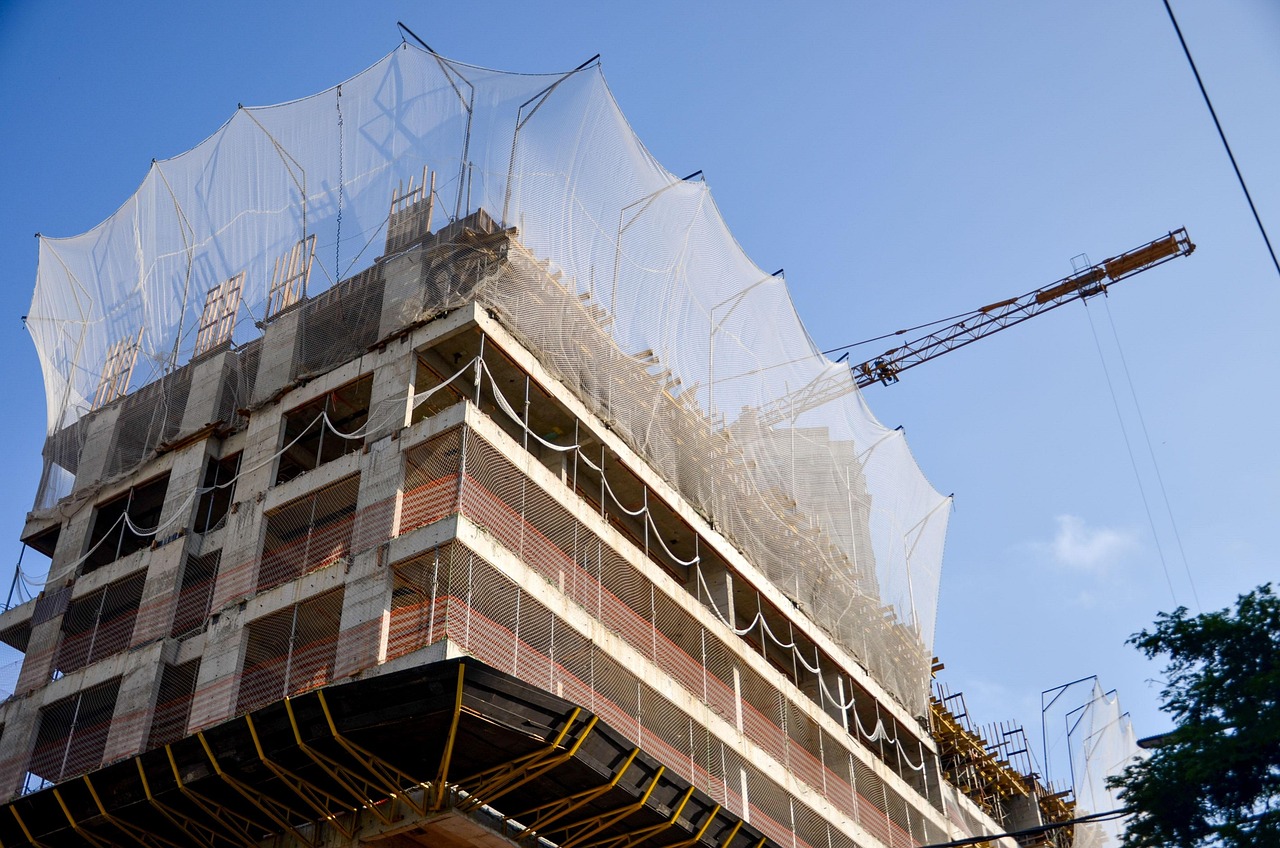 Green shoe option in IPO: a high-rise under construction wrapped in a safety net, much like a cushion under a new listing