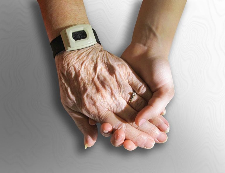 Transmission of shares: an elderly hand held in a younger hand