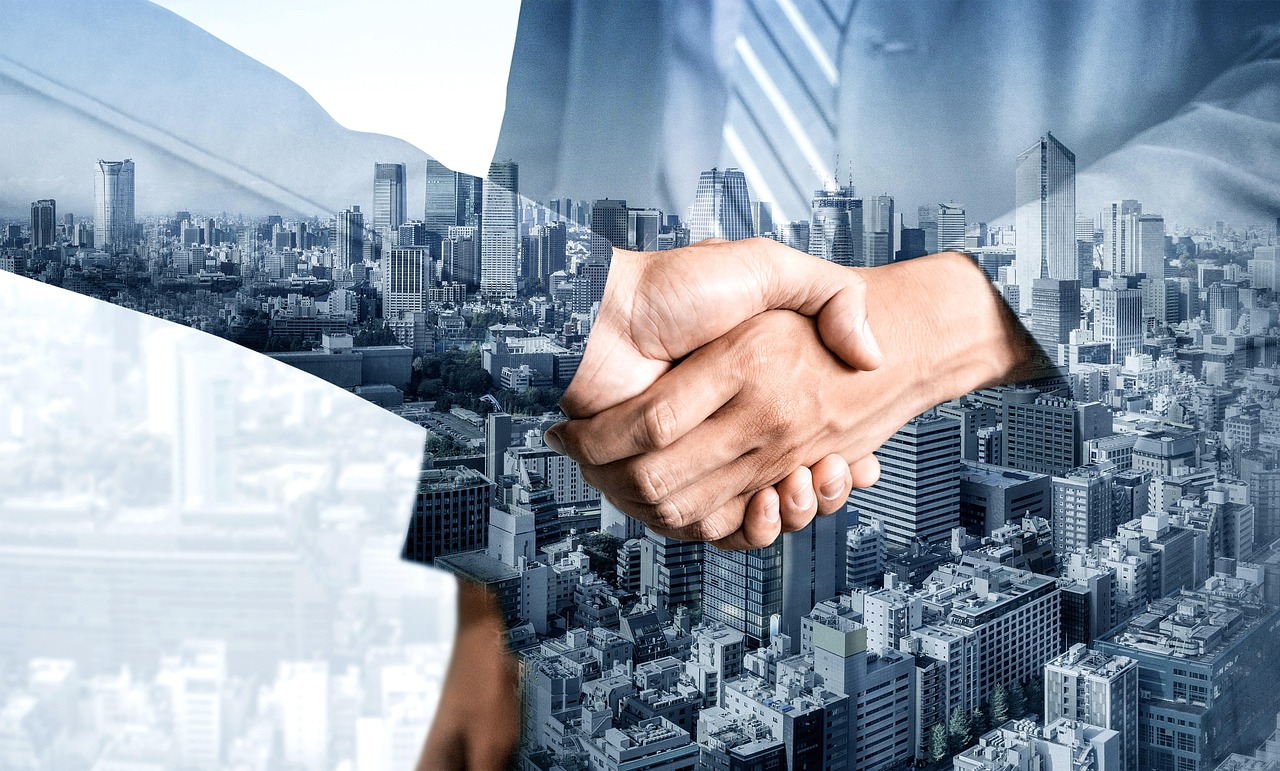 Goodwill impairment in results: two business people shaking hands over a city skyline after an acquisition deal
