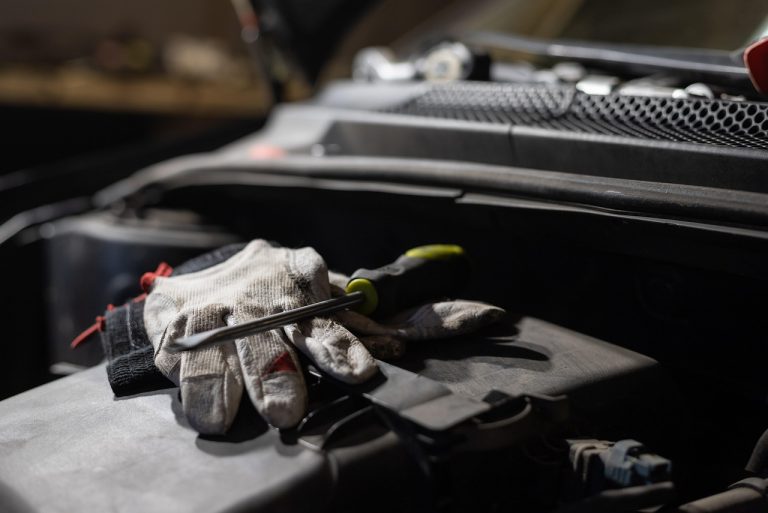 Hyundai Motor India Q2 results: work gloves and a screwdriver resting on a car engine in a workshop