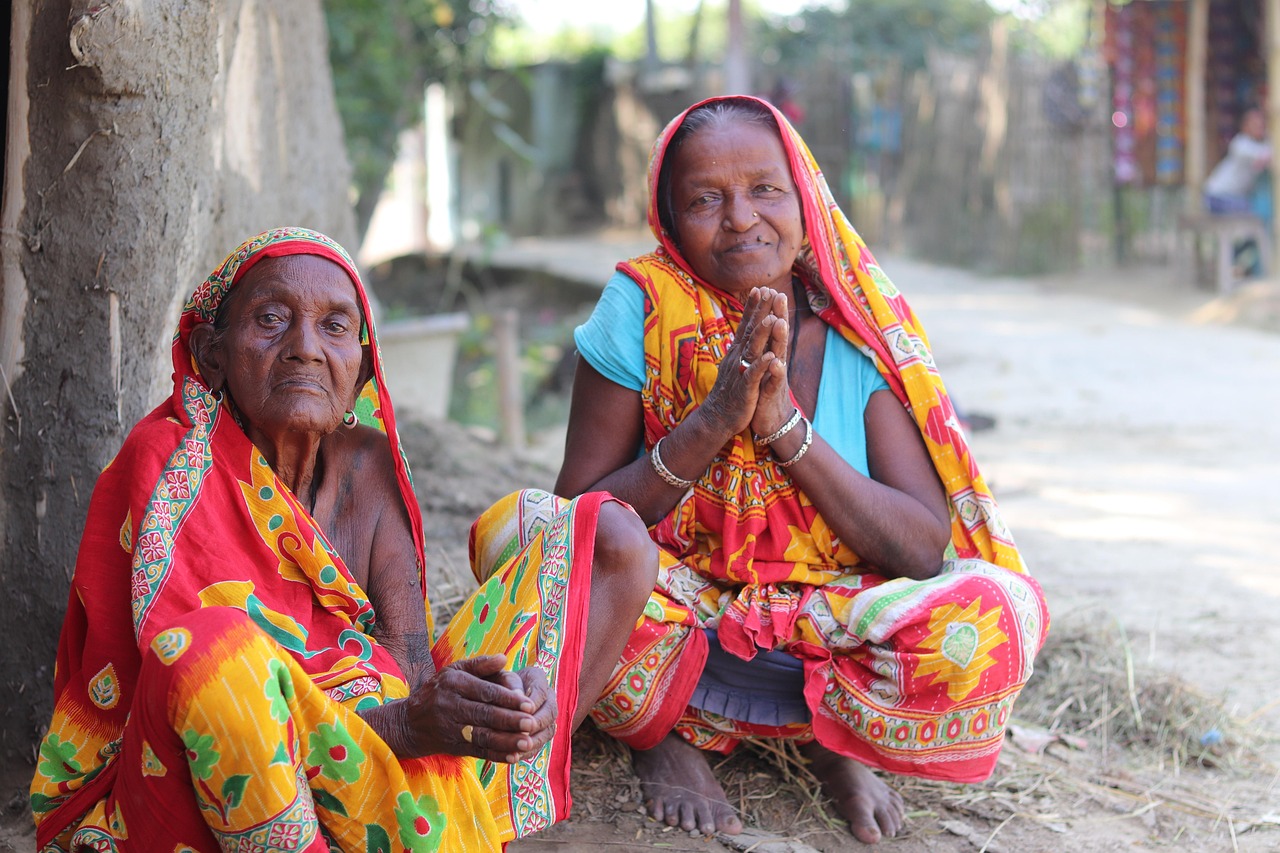 CreditAccess Grameen Q2 results: two women in colourful saris sitting outside in an Indian village