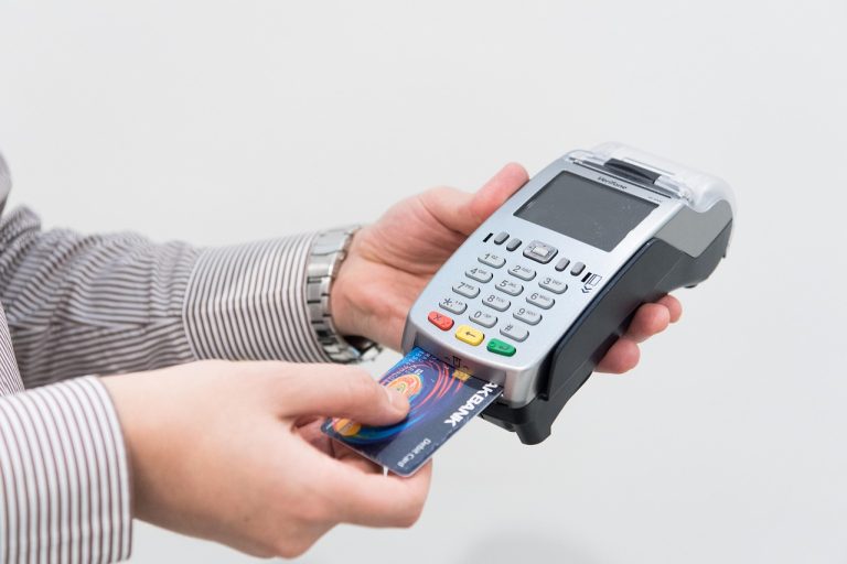 SBI Card Q2 results: a credit card being inserted into a card payment machine