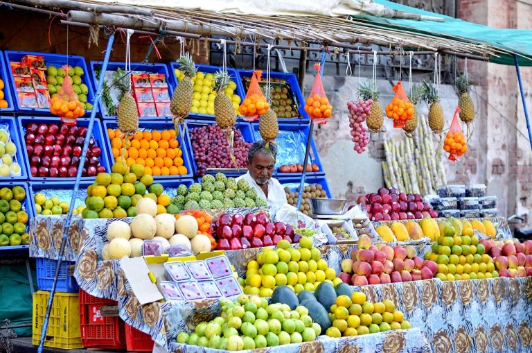 SBFC Finance Q2 results: a fruit stall owner behind a colourful display, the kind of small business SBFC lends to