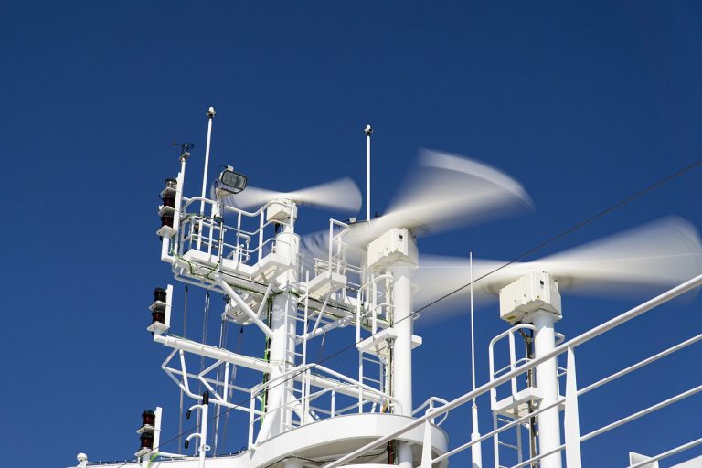 Apollo Micro Systems Q2 results: rotating radar antennas on a white ship mast against a deep blue sky
