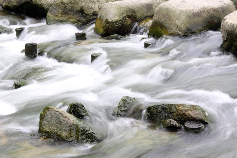Abandoned baby candlestick pattern idea: stones standing alone in rushing water, like a lone doji cut off by gaps on both sides