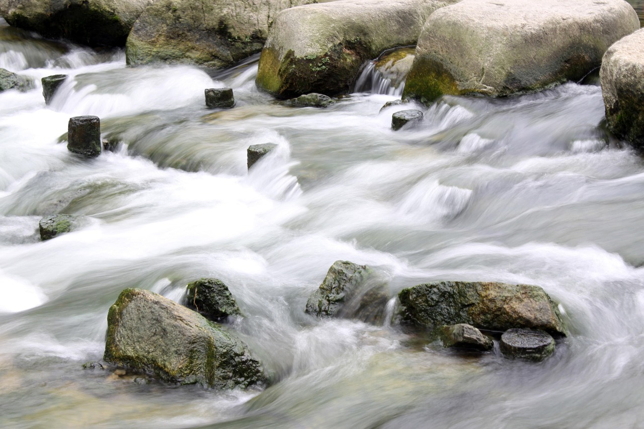 Abandoned baby candlestick pattern idea: stones standing alone in rushing water, like a lone doji cut off by gaps on both sides