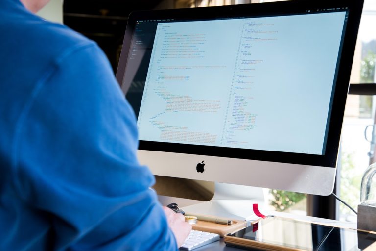 Infosys Q2 results: a software professional working on code at a desktop computer