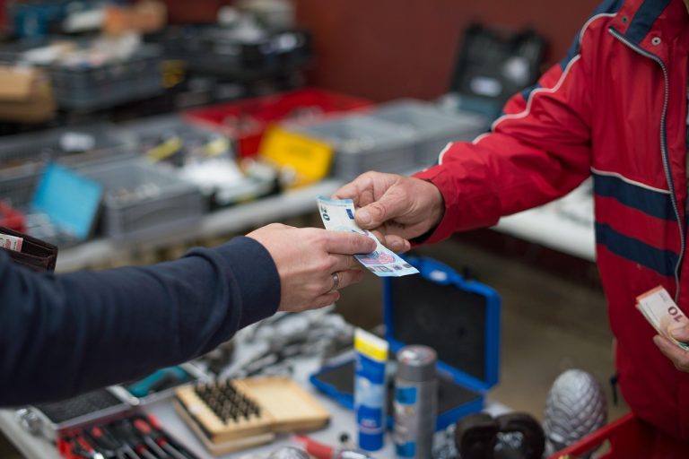 Price to sales ratio: a cash payment changing hands at a market stall