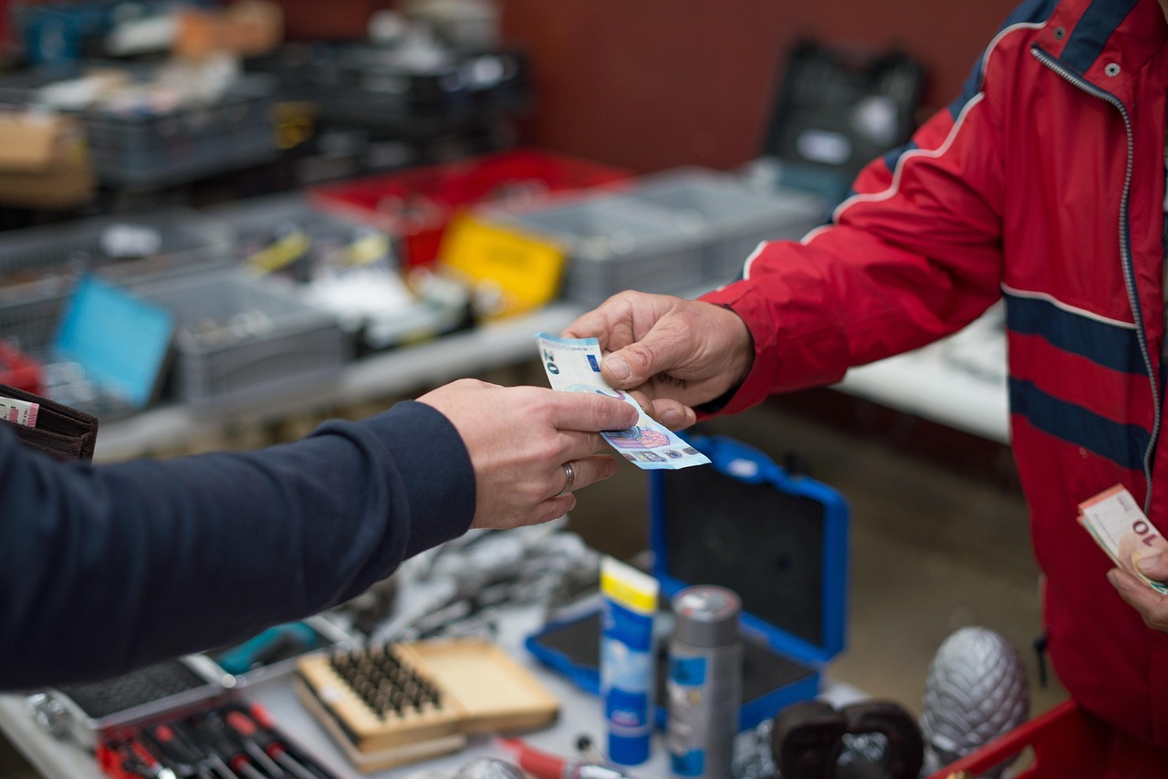 Price to sales ratio: a cash payment changing hands at a market stall