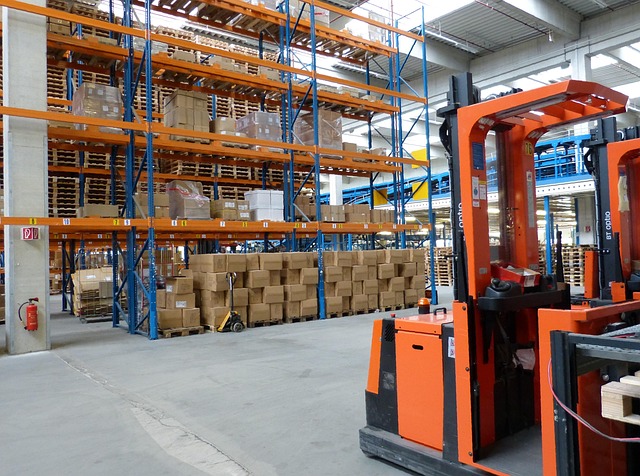 Asset turnover ratio: a busy warehouse with stocked racks and forklifts, the kind of assets a company puts to work to generate sales